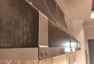 Custom Stainless Steel Basket Weave Strapping on Dark Aged Aluminum Range Hood