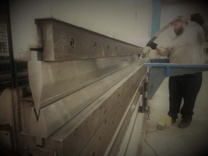 Using our 220 ton CNC press brake, Metal Artist Sparks bends his last piece for a custom copper range hood.